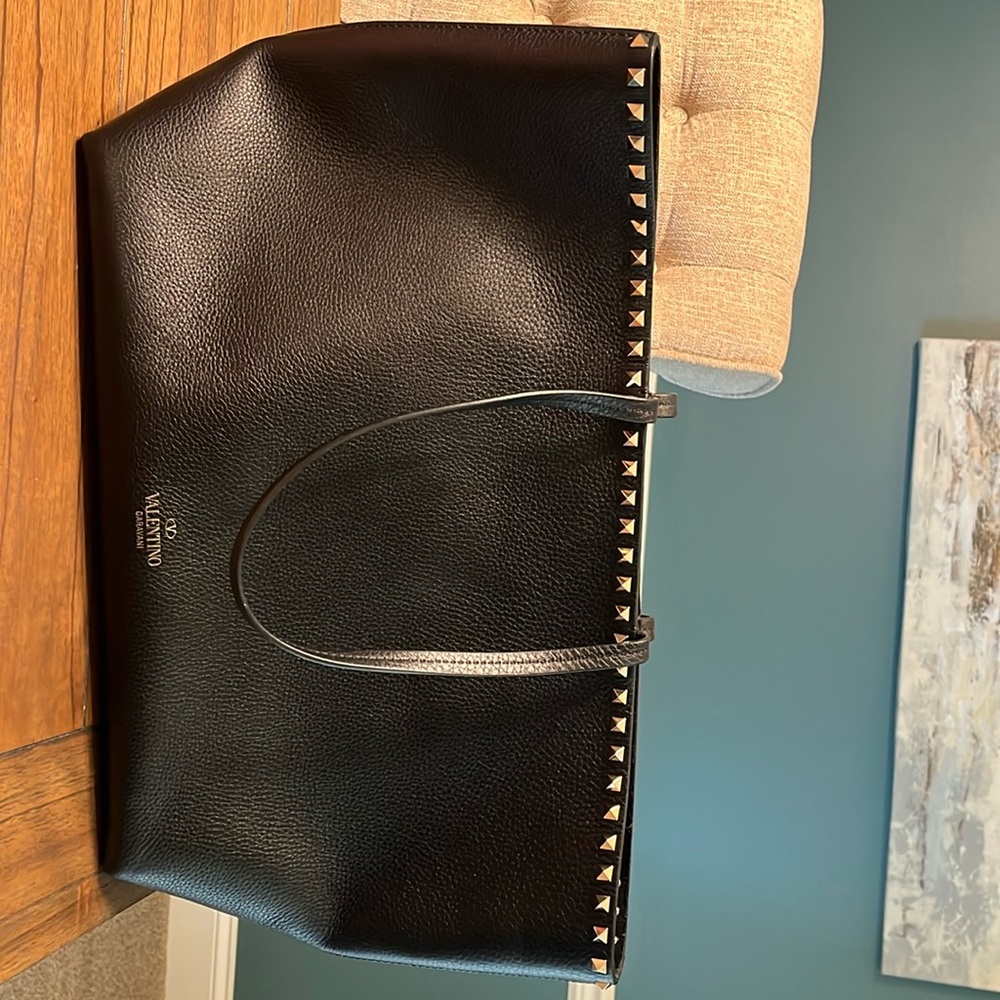 Grainy calfskin leather. Top edge adorned with platinum studs